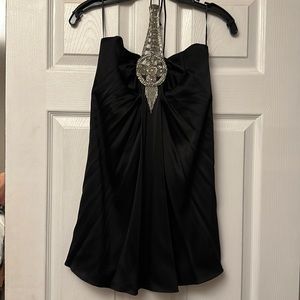 Silk halter top with silver neckline with side zip.. gently used